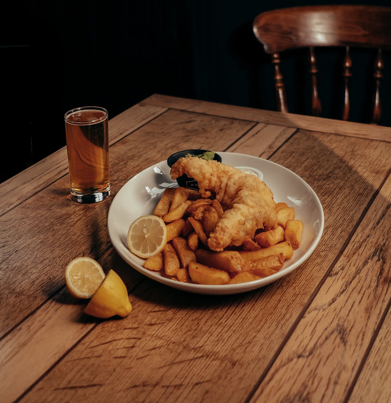 fish potato chips and lemon slice on plate