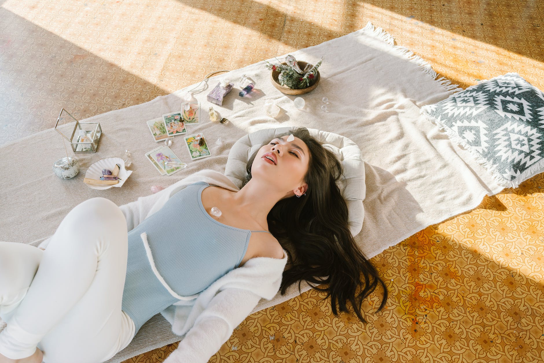 serene asian woman lying with chakra stone on chest relax sleep