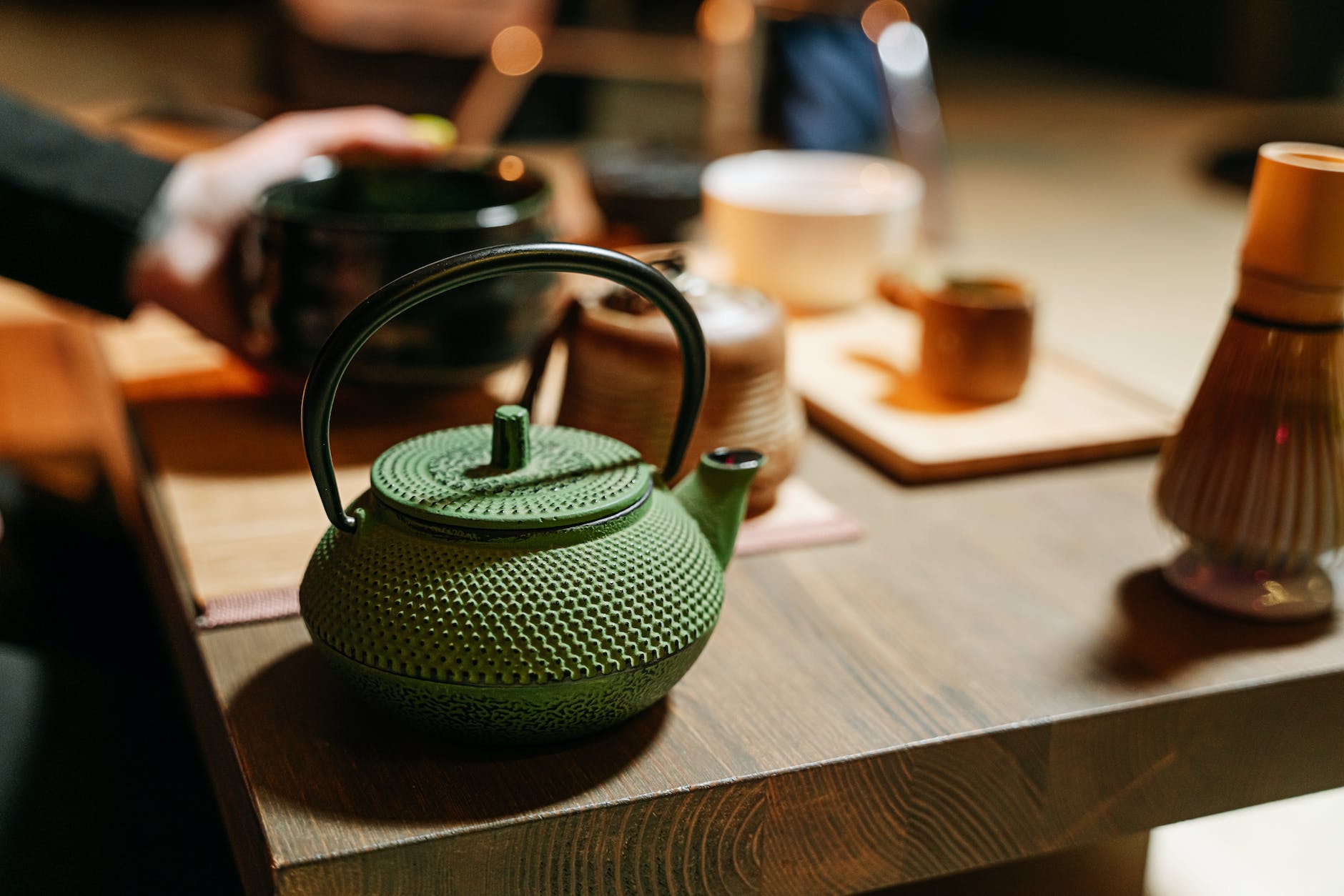 green japanese cast Iron Kettle teapot on wooden table